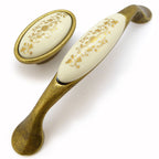 Landhausstil Bogengriffe mit Porzellan-Inlay creme mit Goldmuster